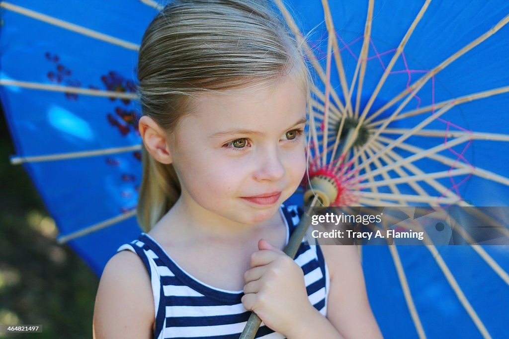 Girl in striped dress with a parasol