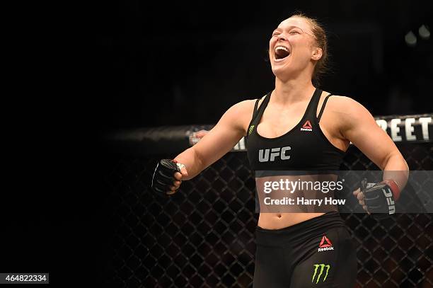 Ronda Rousey celebrates her victory over Cat Zingano in their UFC women's bantamweight championship bout during the UFC 184 event at Staples Center...