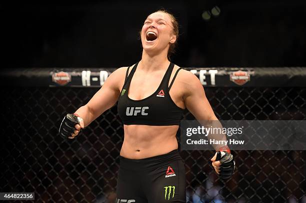 Ronda Rousey celebrates her victory over Cat Zingano in their UFC women's bantamweight championship bout during the UFC 184 event at Staples Center...