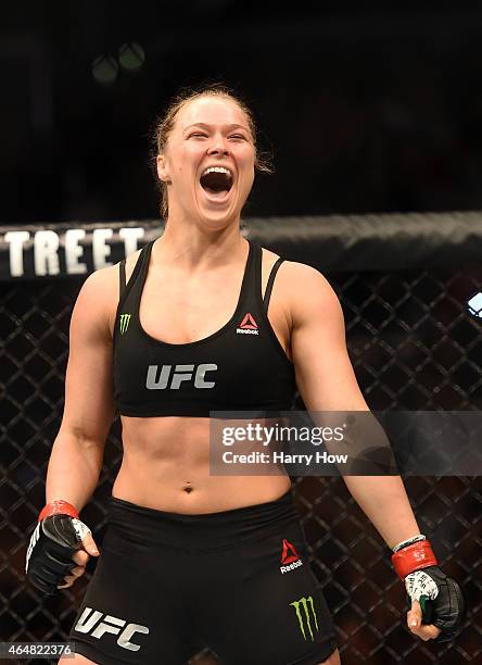 Ronda Rousey celebrates her victory over Cat Zingano in their UFC women's bantamweight championship bout during the UFC 184 event at Staples Center...