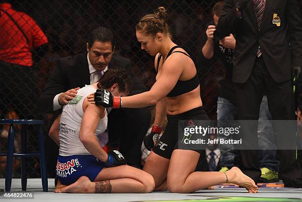 Ronda Rousey consoles Cat Zingano after their UFC women's bantamweight championship bout during the UFC 184 event at Staples Center on February 28,...