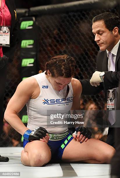 Cat Zingano reacts to her loss to Ronda Rousey by submission after their UFC women's bantamweight championship bout during the UFC 184 event at...