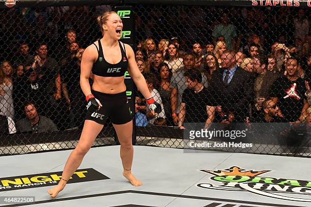 Ronda Rousey celebrates her victory over Cat Zingano in their UFC women's bantamweight championship bout during the UFC 184 event at Staples Center...
