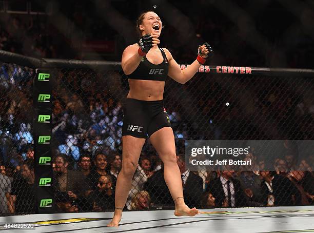 Ronda Rousey celebrates her victory over Cat Zingano in their UFC women's bantamweight championship bout during the UFC 184 event at Staples Center...