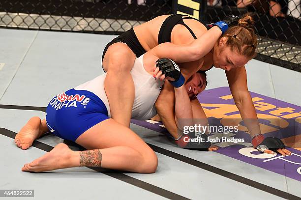 Ronda Rousey grapples with Cat Zingano in their UFC women's bantamweight championship bout during the UFC 184 event at Staples Center on February 28,...