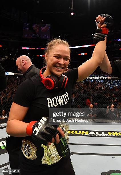 Ronda Rousey celebrates her victory over Cat Zingano in their UFC women's bantamweight championship bout during the UFC 184 event at Staples Center...