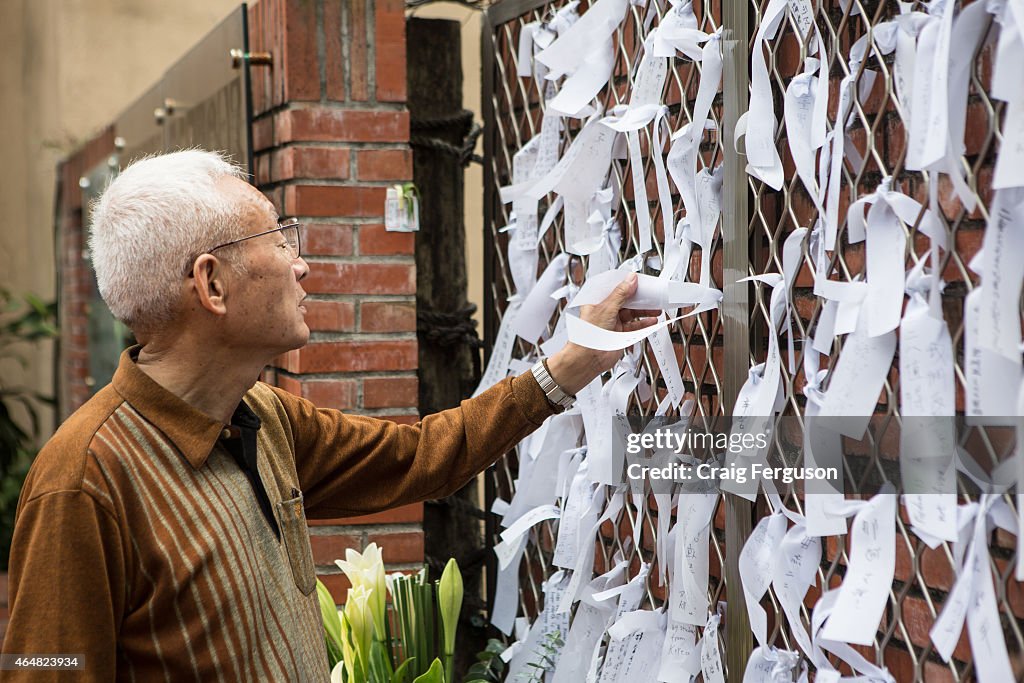 An elderly Taiwanese man reads messages of peace and...