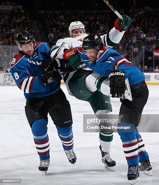 Jan Hejda and Brad Stuart of the Colorado Avalanche defend against Charlie Coyle of the Minnesota Wild at Pepsi Center on February 28, 2015 in...