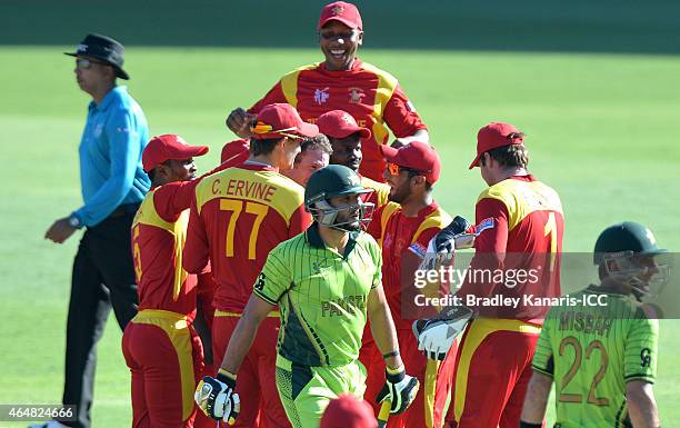 Sean Williams of Zimbabwe and team mates celebrate as Shahid Afridi of Pakistan walks from the field after being dismissed for a duck during the 2015...