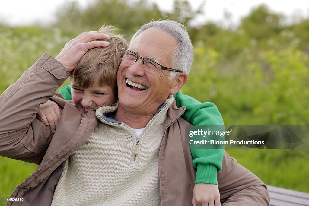 Grandfather and grandson laughing