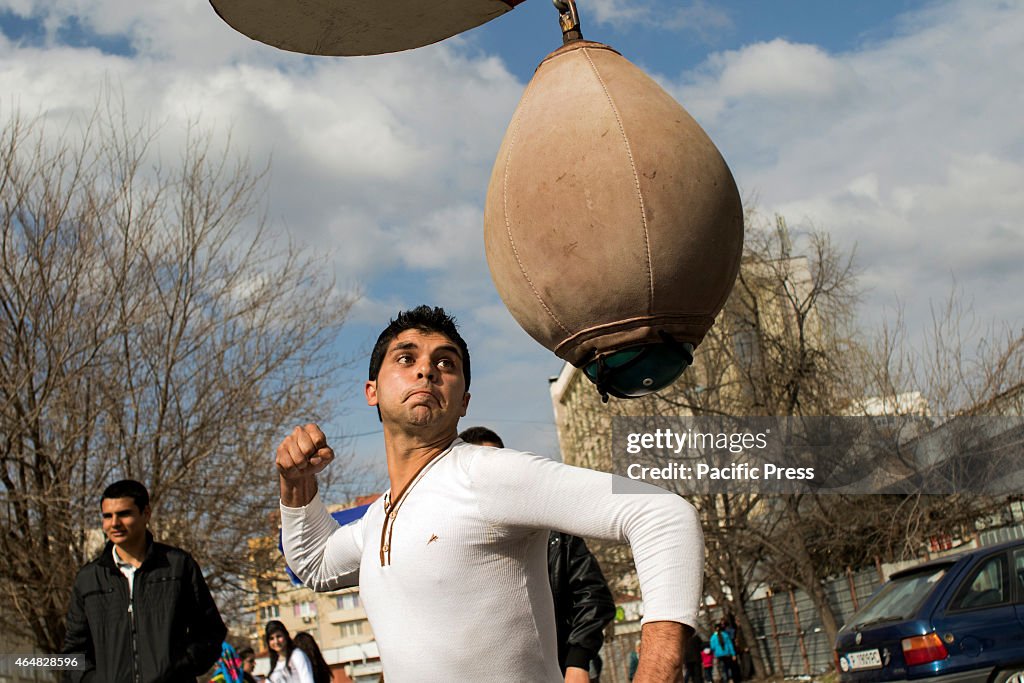 A boy showing his strength to attract young girls in the...