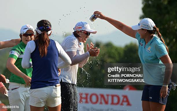 South Korean golfers congratulate compatriot Amy Yang after the final round of the Honda LPGA Thailand 2015 golf tournament in Pattaya on March 1,...