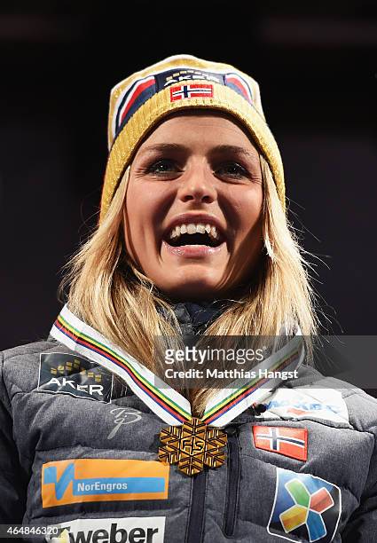 Therese Johaug of Norway poses with her gold medal during the medal ceremony for the Women's 30km Mass Start Cross-Country during the FIS Nordic...