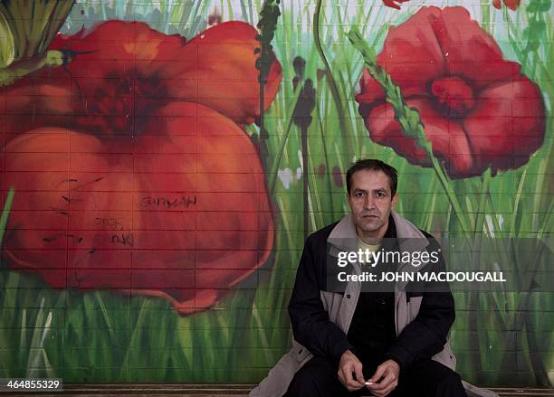 Bosnian Roma actor Nazif Mujic, who won a Silver Bear for best actor at the Berlinale Film Festival in February 2013, poses in a waiting area outside...