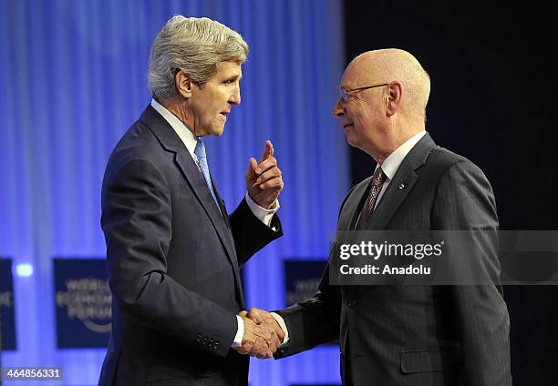 John F. Kerry , US Secretary of State, shakes hands with Klaus Schwab , Founder and Executive Chairman, World Economic Forum, during his 'Special...