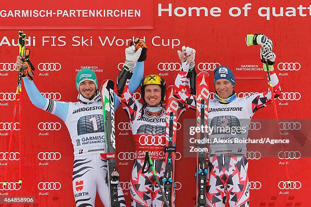 Marcel Hirscher of Austria takes 1st place, Felix Neureuther of Germany takes 2nd place, Benjamin Raich of Austria takes 3rd place during the Audi...