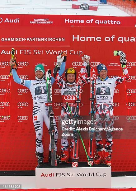 Marcel Hirscher of Austria takes 1st place, Felix Neureuther of Germany takes 2nd place, Benjamin Raich of Austria takes 3rd place during the Audi...