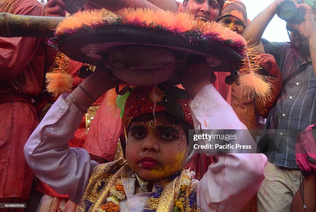 A child bringing his armor during the Holi festival. Holi is...