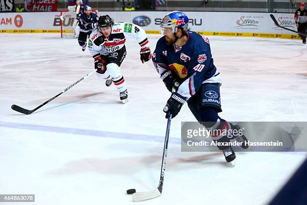 Daniel Sparre of Muenchen is challenge by Ryan Jones of Koeln during the DEL Ice Hockey match between EHC Red Bull Muenchen and Koelner Haie at...