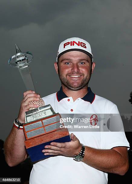 Andy Sullivan of England poses with the trophy after winning the Joburg Open at Royal Johannesburg and Kensington Golf Club on a score of -17 under...