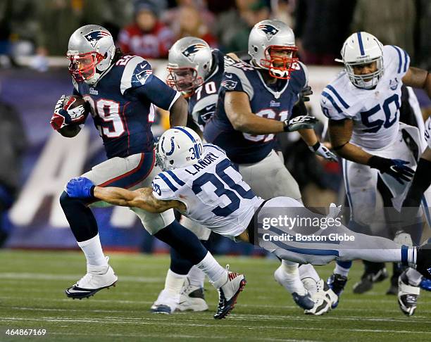 Patriots running back LeGarrette Blount eludes Colts safety LaRon Landry, the last man en route to a 73 yard touchdown run during the fourth quarter...