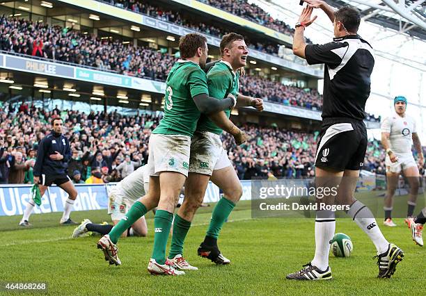 Robbie Henshaw of Ireland is congratulated by teammate Jared Payne of Ireland after scoring the opening try during the RBS Six Nations match between...