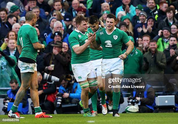 Robbie Henshaw of Ireland is congratulated by teammates after scoring the opening try during the RBS Six Nations match between Ireland and England at...