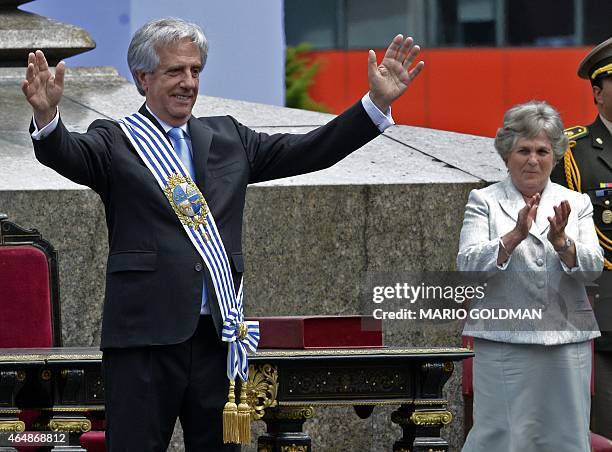 Uruguay's new President Tabare Vazquez, already wearing the presidential sash, waves at the public during his inauguration at Independencia Square in...