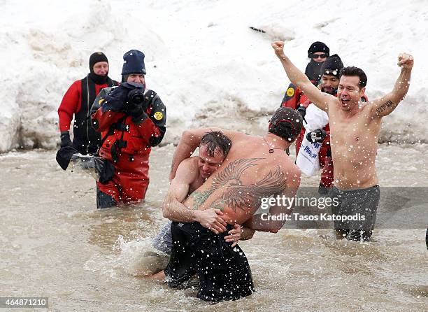 David Eigenberg, Taylor Kinney and Jon Seda participates in the Chicago Polar Plunge 2015 at North Avenue Beach on March 1, 2015 in Chicago, Illinois.