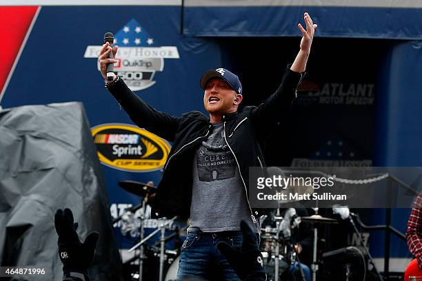 Musician Cole Swindell performs in the infield before the NASCAR Sprint Cup Series Folds of Honor QuikTrip 500 at Atlanta Motor Speedway on March 1,...