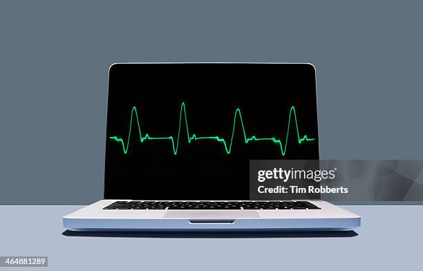 laptop with healthy heartbeat pulse. - pulse trace stock pictures, royalty-free photos & images