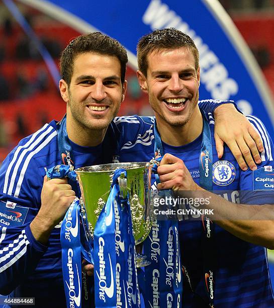 Spanish players Cesar Azpilicueta and Cesc Fabregas celebrate with the trophy during the presentation after Chelsea won the League Cup final football...