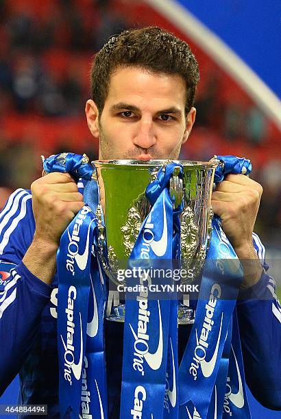 Chelsea's Spanish midfielder Cesc Fabregas kisses the trophy during the presentation after Chelsea won the League Cup final football match against...