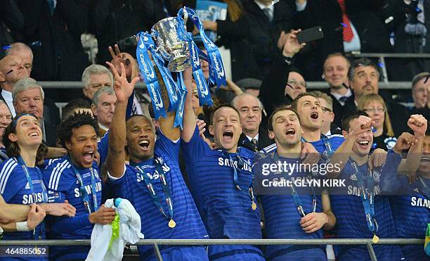 Chelsea's Ivorian striker Didier Drogba and Chelsea's English defender John Terry lift the trophy during the presentation after Chelsea won the...