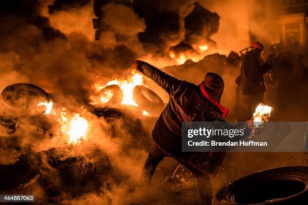 An anti-government protester throws a Molotov cocktail during clashes with police on Hrushevskoho Street near Dynamo stadium on January 25, 2014 in...