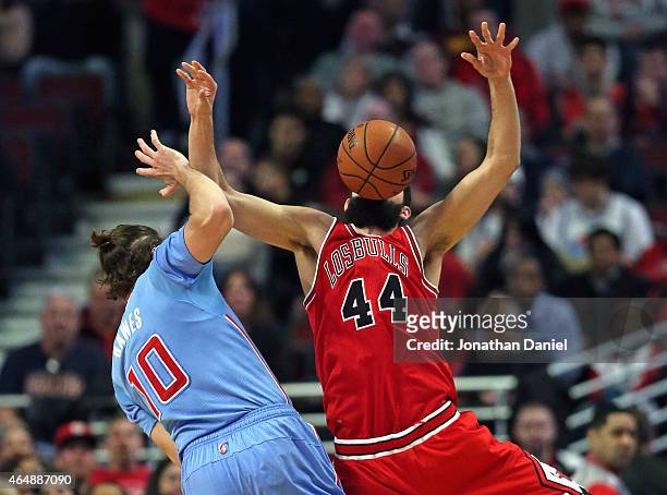 Nikola Mirotic of the Chicago Bulls looses the ball after being fouled by Spencer Hawes of the Los Angeles Clippers at the United Center on March 1,...