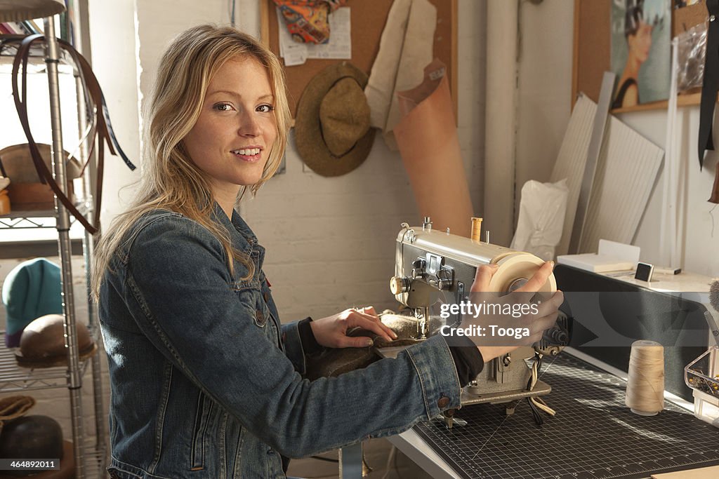 Woman sitting at vintage sewing machine