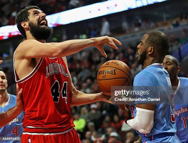 Chris Paul of the Los Angeles Clippers knocks the ball away from Nikola Mirotic of the Chicago Bulls at the United Center on March 1, 2015 in...