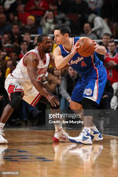 Mike James of the Chicago Bulls guards J.J. Redick of the Los Angeles Clippers on January 24, 2014 at the United Center in Chicago, Illinois. NOTE TO...