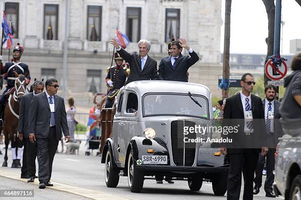 President of Uruguay, Tabare Vasquez and Vice President Raul Sendic greet the public from the vehicle that takes them from the Parliament toward the...