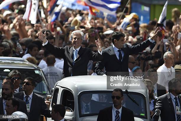 President of Uruguay, Tabare Vasquez and Vice President Raul Sendic greet the public from the vehicle that takes them from the Parliament toward the...