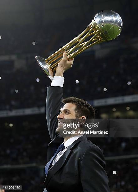 Basketball player Felipe Reyes of Real Madrid holds the recently won Copa del Rey trophy before the La Liga match between Real Madrid CF and...