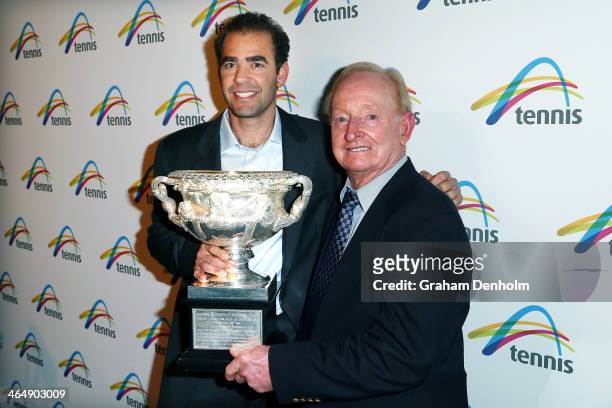 Former tennis players Rod Laver and Pete Sampras pose with the Norman Brookes Challenge Cup as they arrive at the Legends Lunch during day 13 of the...