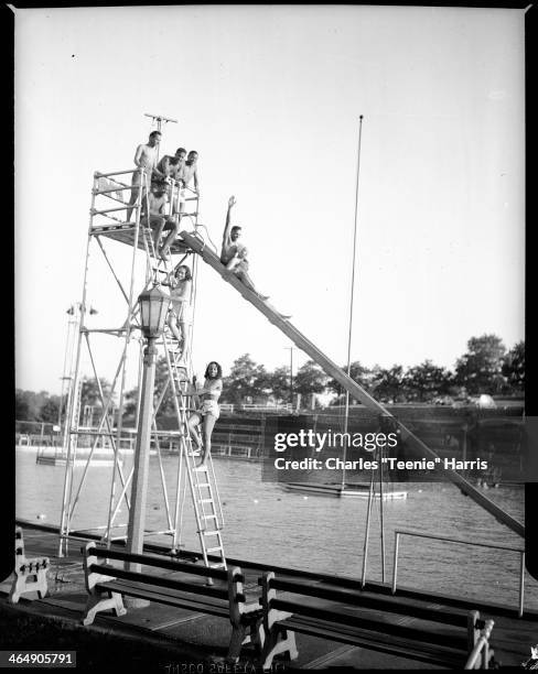 Lois Weaver Watson and Rosemarie Lawrence climbing ladder, Frank Entry seated, Don Matheus, Jimmy Bertha, Mozelle Thompson standing, and William...