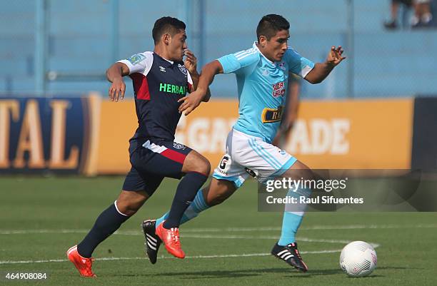 Irven Avila of Sporting Cristal struggles for the ball with Joel Sanchez of San Martin during a match between Sporting Cristal and San Martin as part...