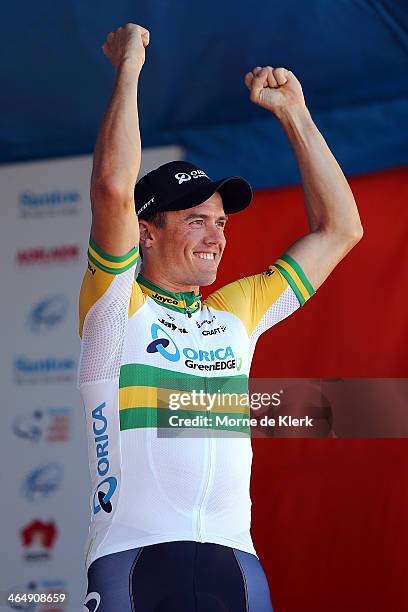 Australian cyclist Simon Gerrans of the Orica GreenEDGE team celebrates before being presented with the leaders Ochre Jersey after Stage Five of the...