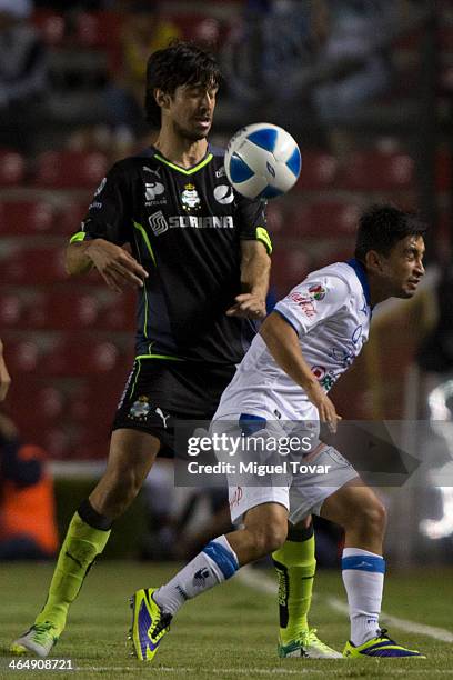 Christian Bermudez of Queretaro fights for the ball with Jonathan Lacerda of Santos during a match between Queretaro and Pumas UNAM as part of the...