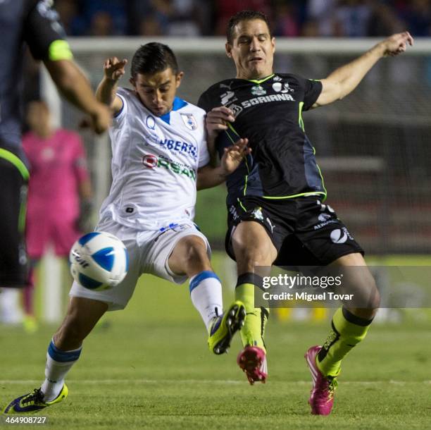 Christian Bermudez of Queretaro fights for the ball with Rafael Figueroa of Santos during a match between Queretaro and Pumas UNAM as part of the...