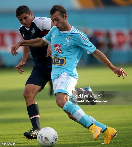 Horacio Calcaterra of Sporting Cristal struggles for the ball with Aldo Corzo of San Martin during a match between Sporting Cristal and San Martin as...