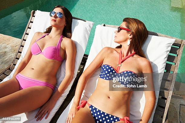 bikini rivals - poolside glamour stock pictures, royalty-free photos & images